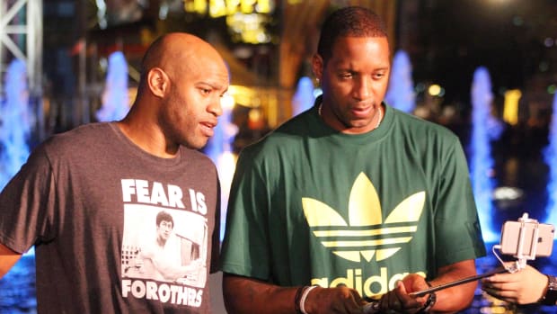 Former NBA basketball players Vince Carter (left) and Tracy McGrady (right) take a selfie together.